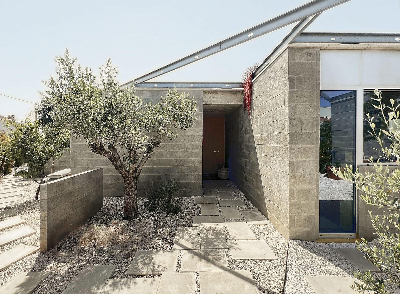 triphase house — the entrance court under the steel roof
