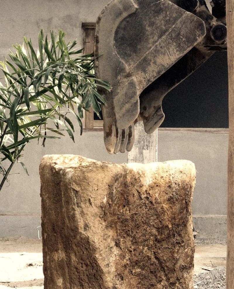 on site — the excavator and the stone