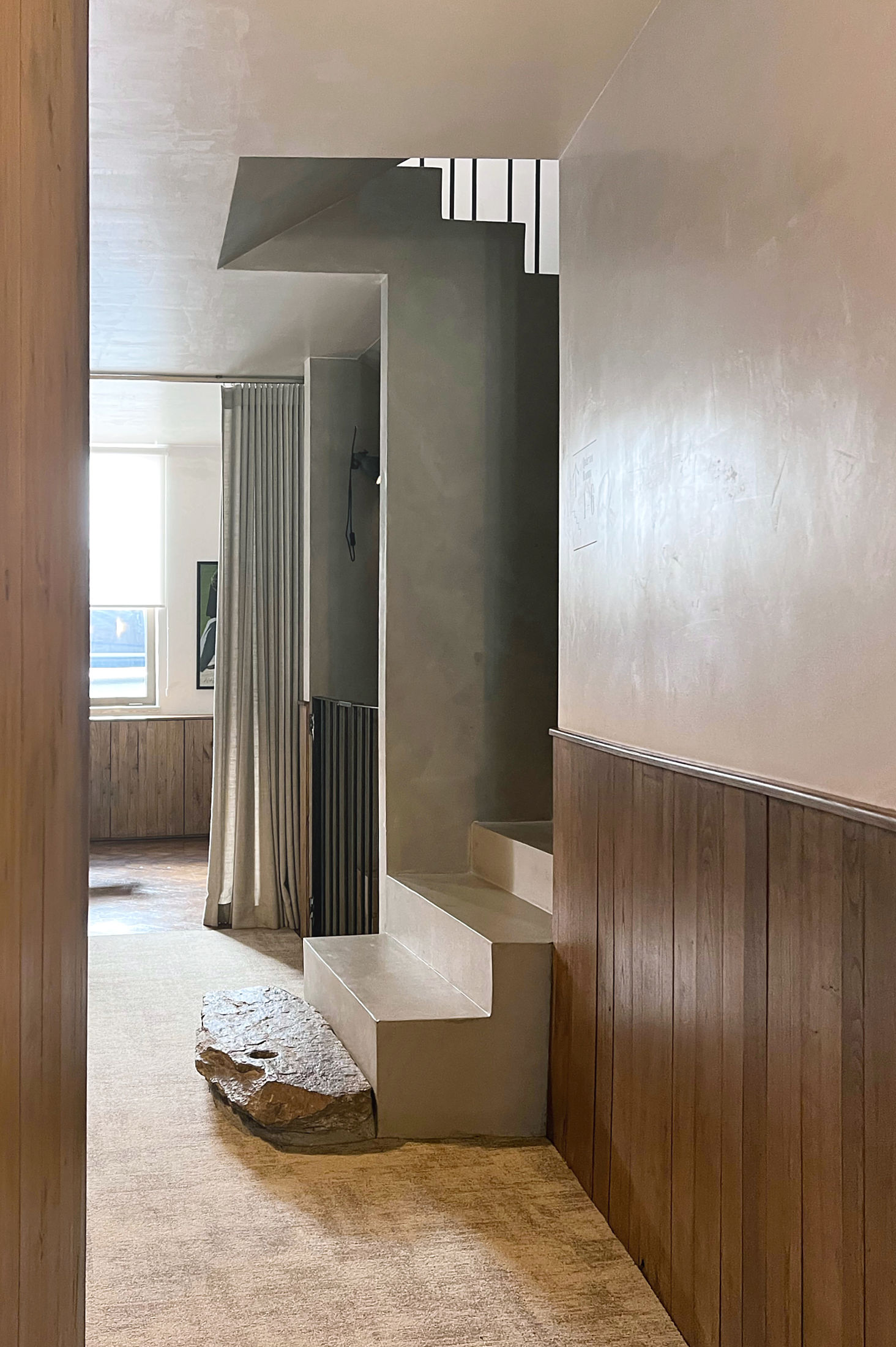 photograph — the stair lands on a granite stone